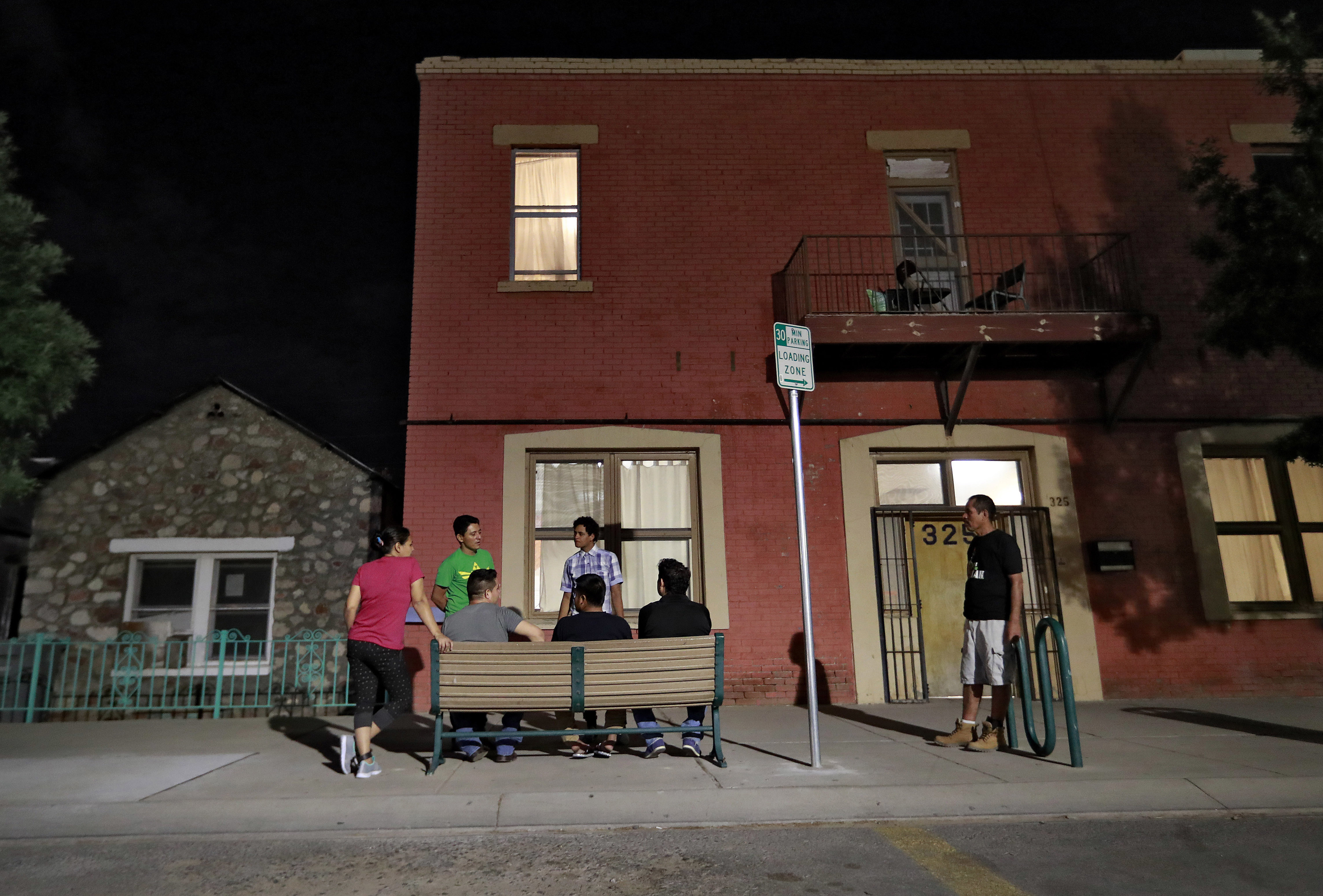 FILE - Migrant parents socialize outside the Annunciation House, June 26, 2018, in El Paso, Texas. A Texas judge ruled against the state attorney general on Tuesday, July 2, 2024, in his effort to shut down a migrant shelter in El Paso that he claimed encourages illegal migration. (AP Photo/Matt York, File)