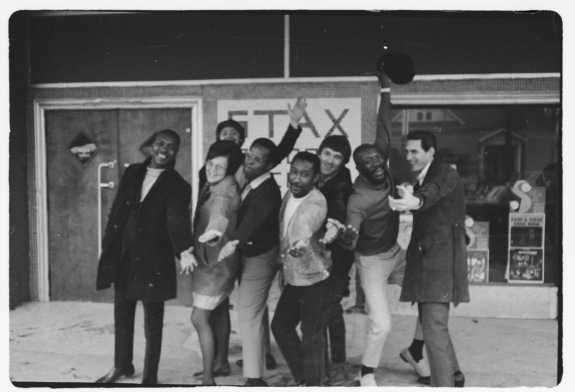 A group of musicians pose outside Stax Records. 