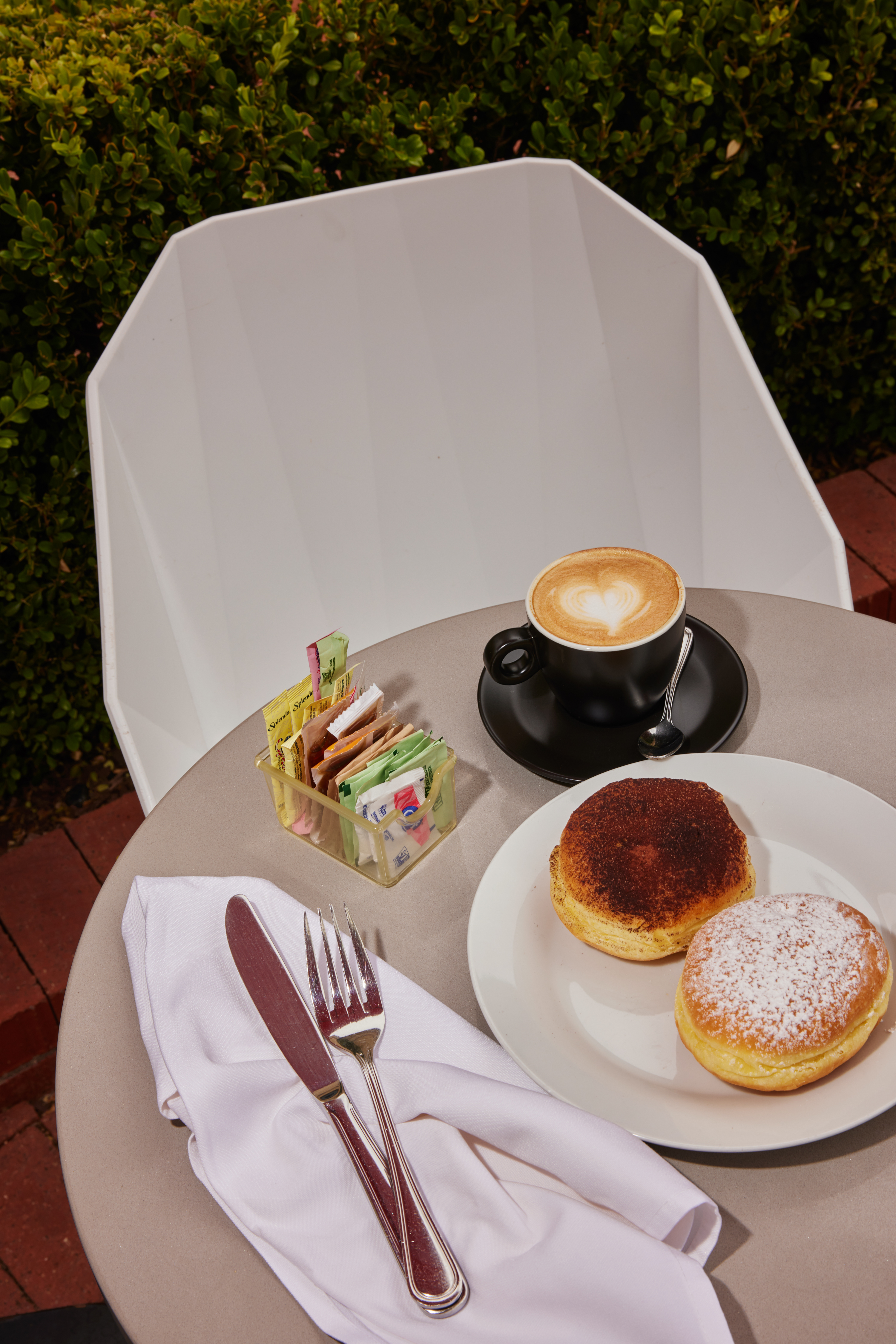 An outdoor table with pastries and coffee from edo bites in Pacific Palisades.