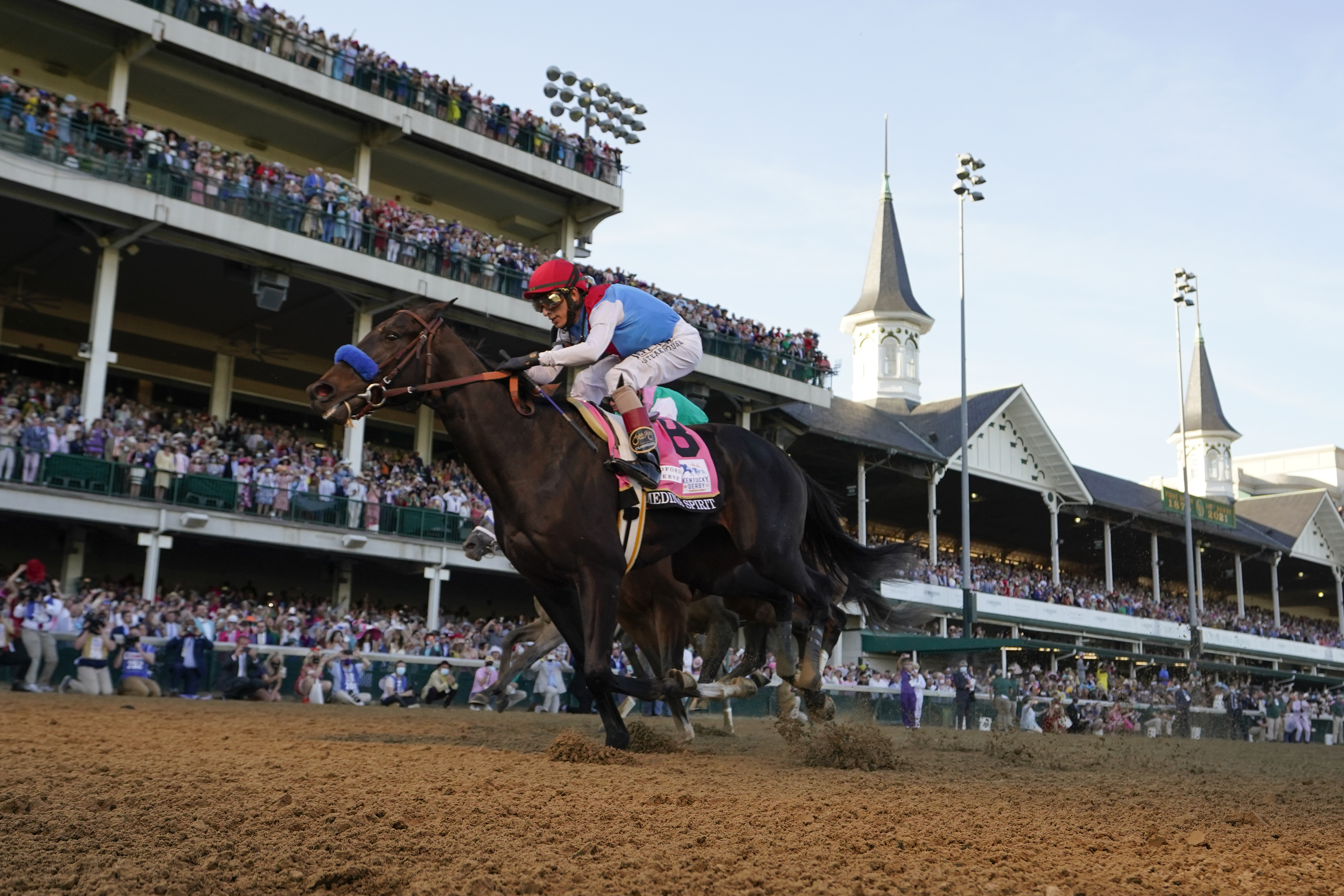 John Velazquez rides Medina Spirit across the finish line to win the Kentucky Derby at Churchill Downs.