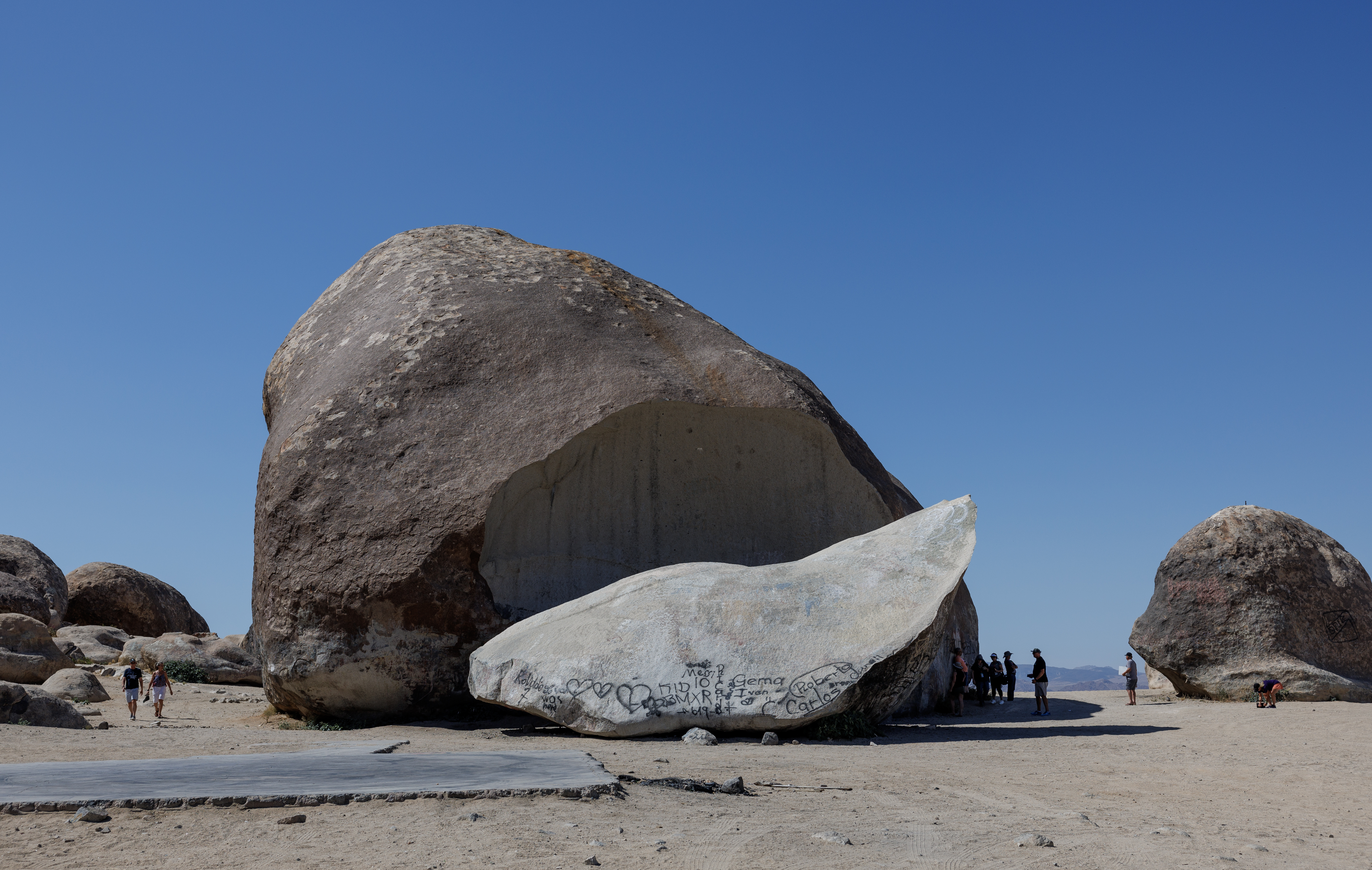 LANDERS, CA - MAY 30, 2024: A group from Contact in the Desert, a UFO convention, visits the Giant Rock, a seven story high boulder in the Mojave Desert on May 30 2024 in Landers, California. (Gina Ferazzi / Los Angeles Times)