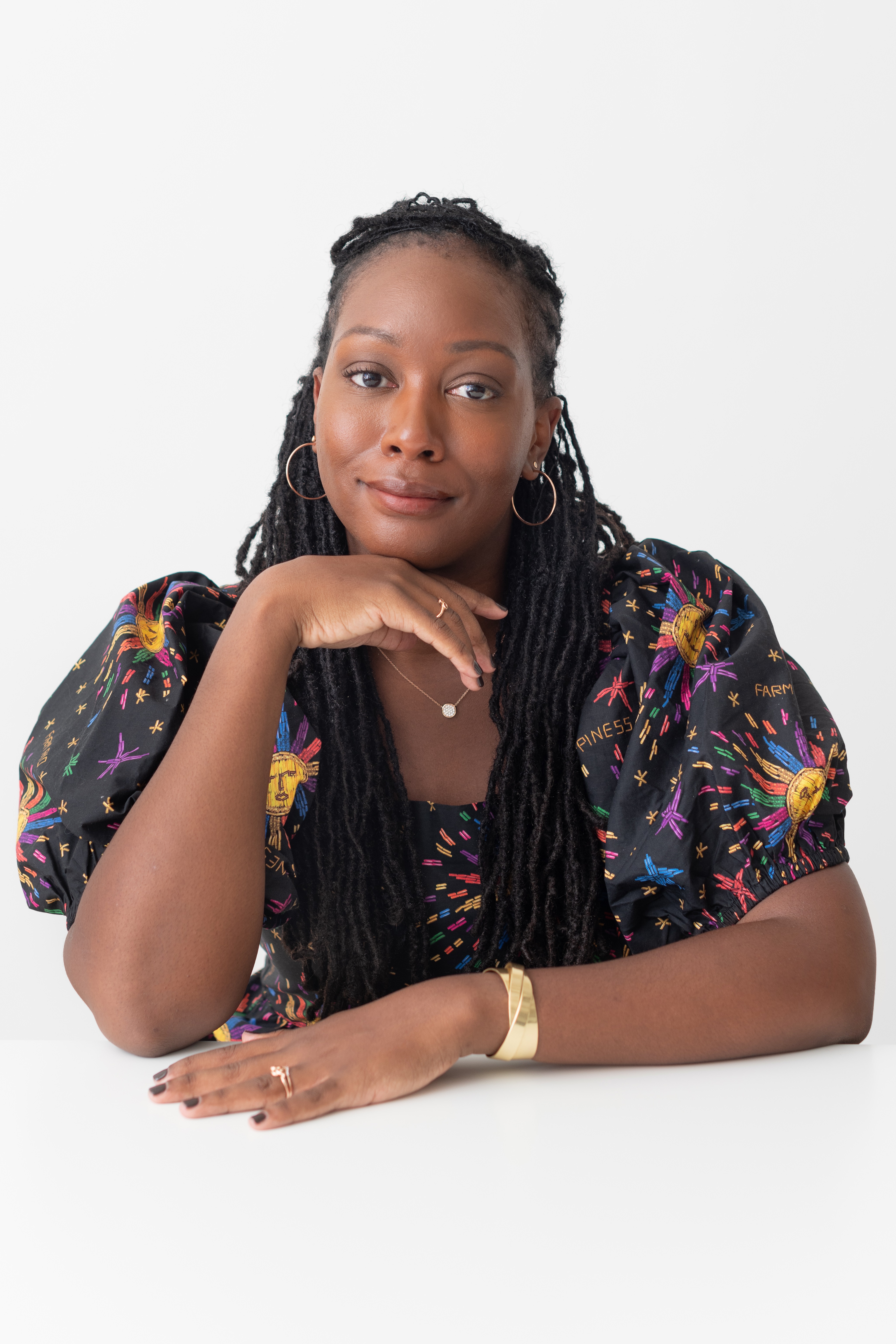 Portrait of Sarai Johnson seated and smiling at camera 