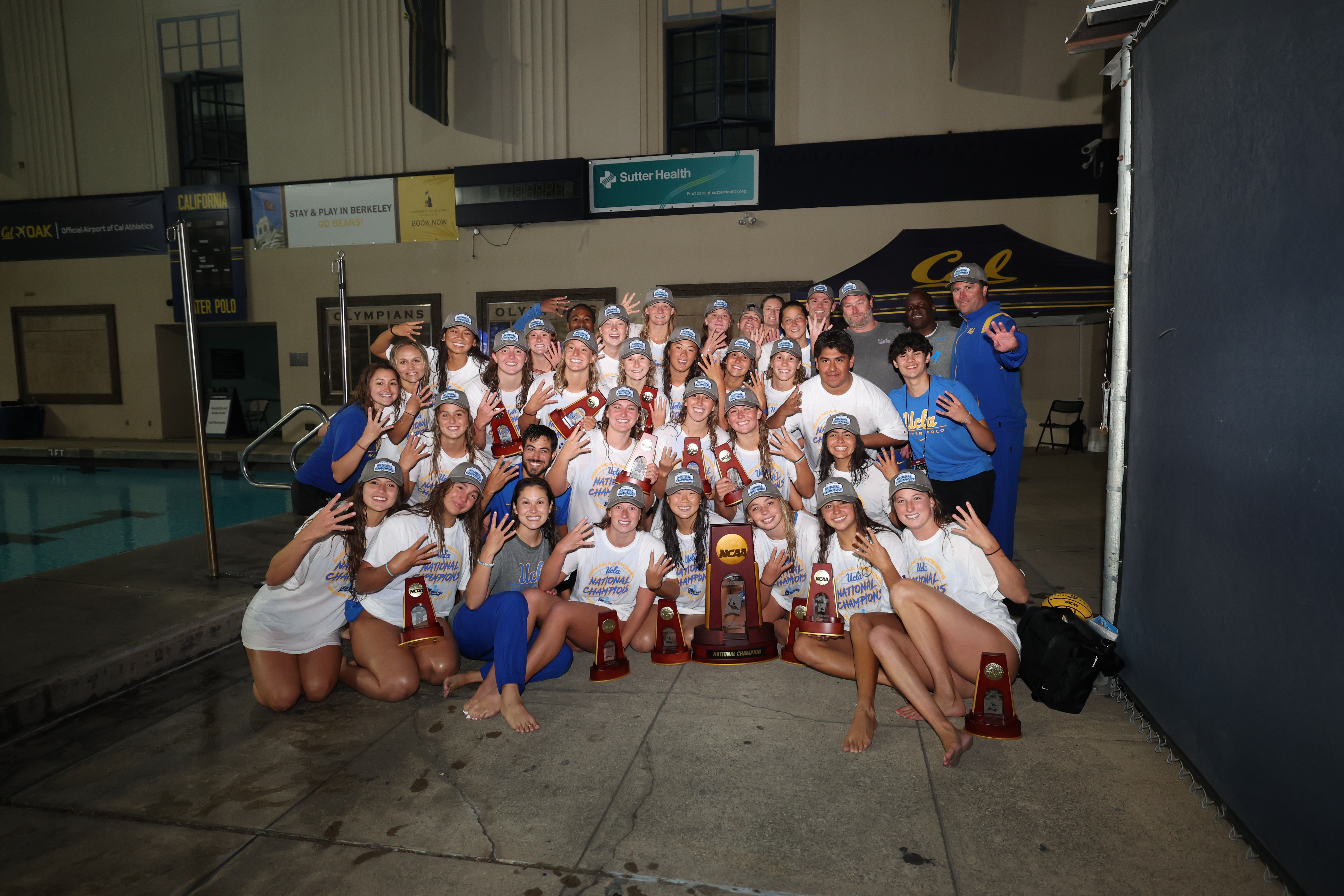 Members of the UCLA women's water polo team celebrate.