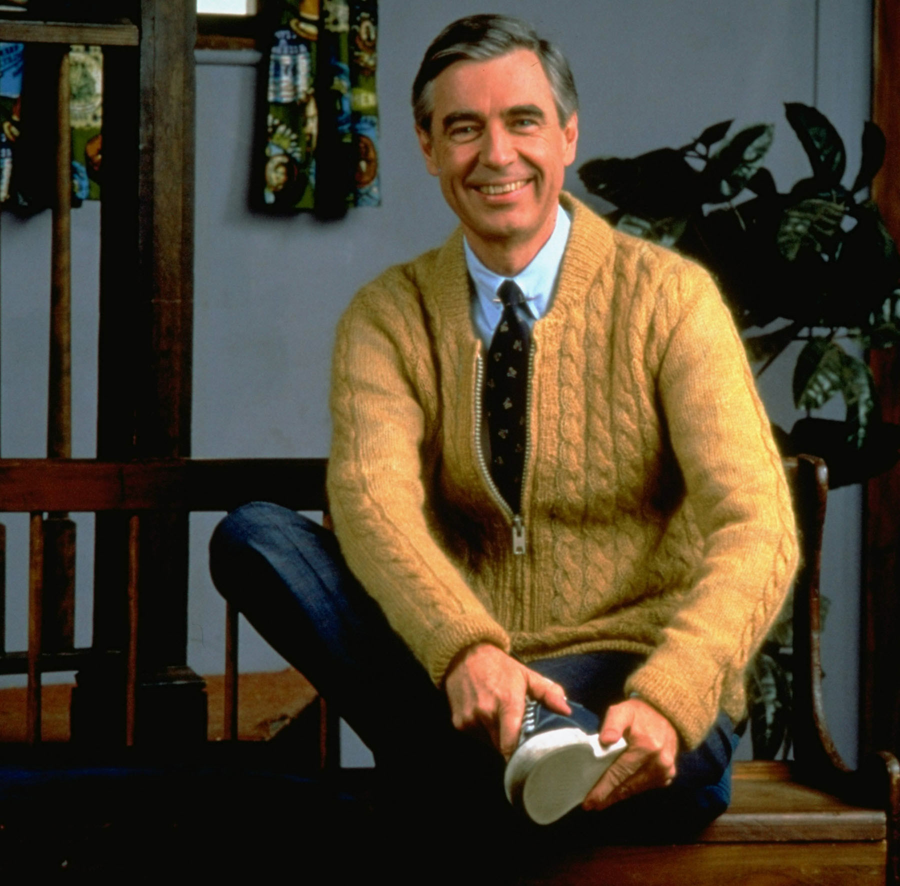 ** FILE ** Fred Rogers poses on the Pittsburgh set of his television show Mister Rogers' Neighborhood, in this 1996 publicity photo. Fred Rogers, who gently invited millions of children to be his neighbor as host of the public television show Mister Rogers Neighborhood for more than 30 years, died of cancer early Thursday, February 27, 2003. He was 74. (AP Photo/pool) ORG XMIT: NY122