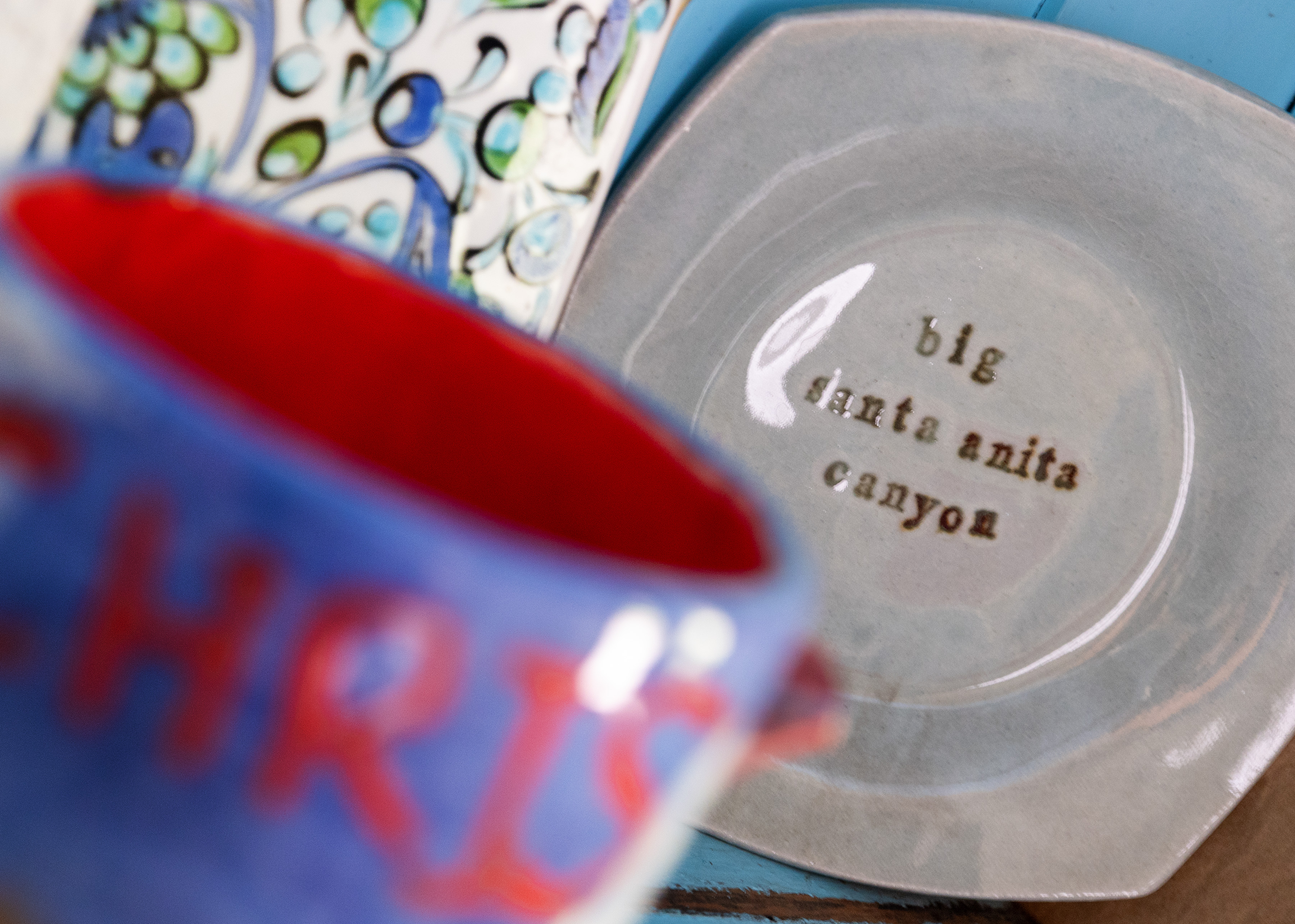 Ceramic plate reads "big santa anita canyon" in a hutch inside the Kastens' cabin.