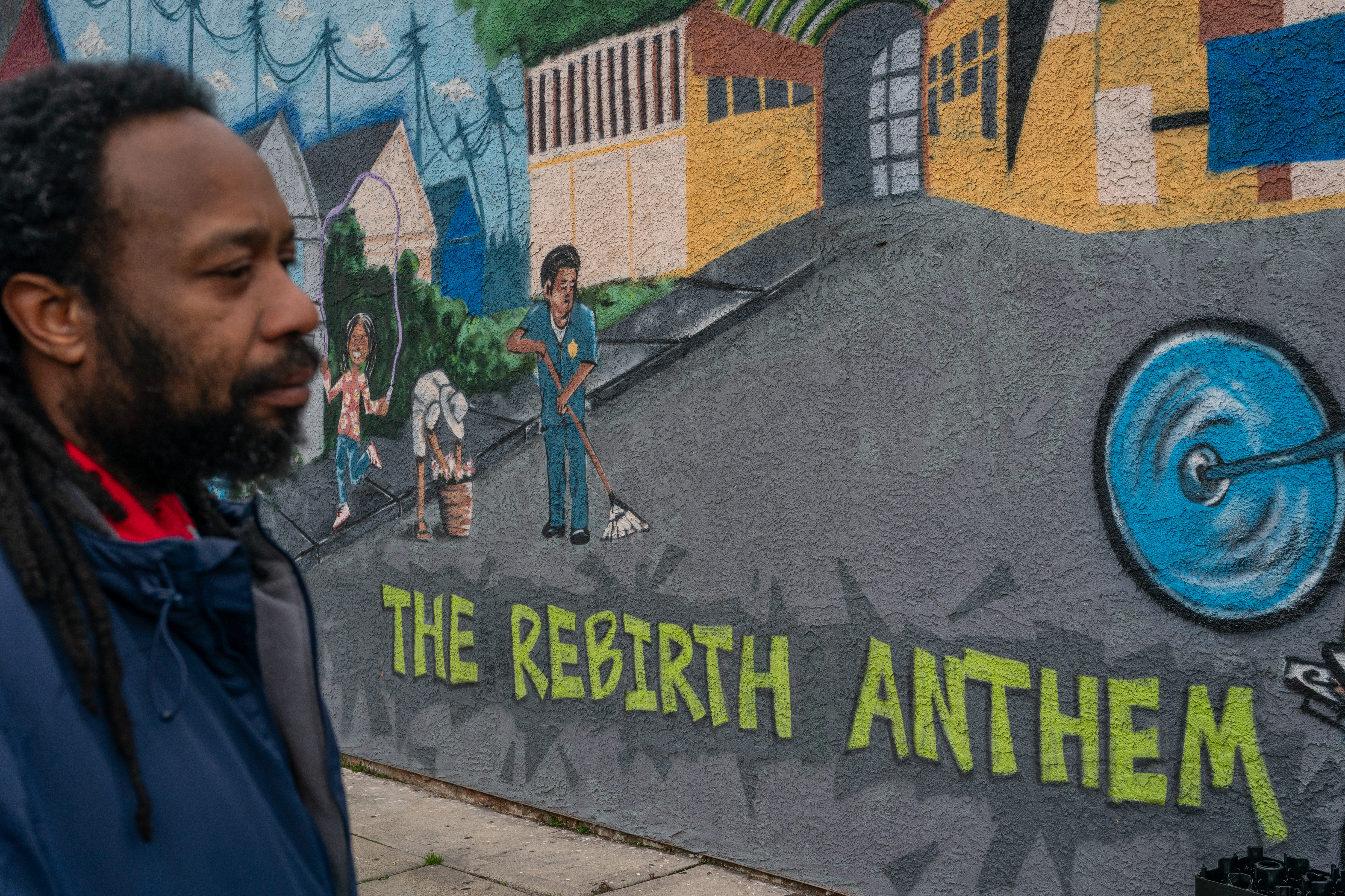 OAKLAND CA MARCH 1, 2024 - Artist Derrick Shavers stands by the mural he painted on the side of the Handy Corner Market at Scoville Street and 57th Avenue on Friday, March 1, 2024 in Oakland, California. Local homeowner Keisha Henderson worked with community partners and her local government to clean up the area. (Loren Elliott / For The Times)