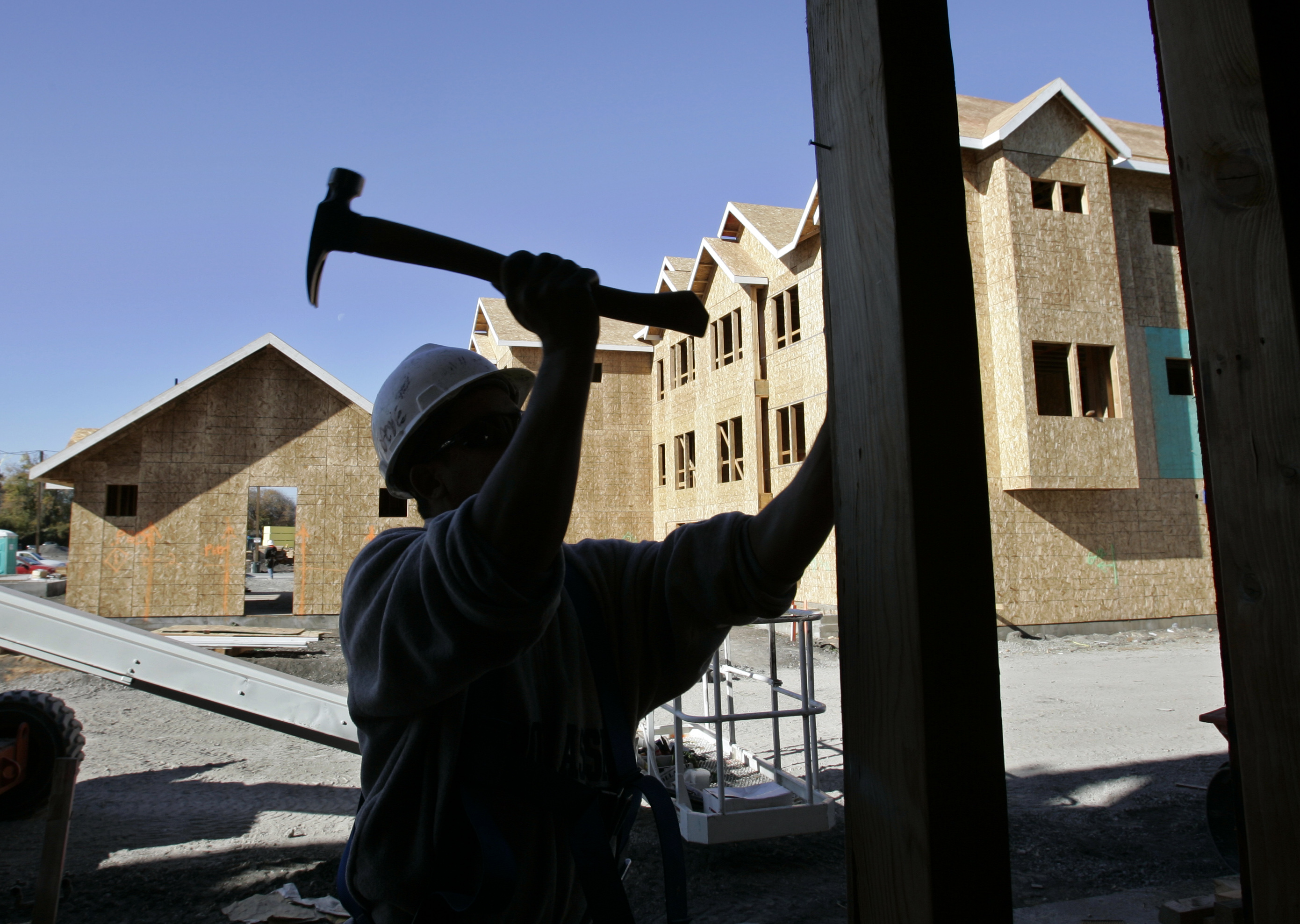 ** FILE ** In this Nov. 30, 2007, file photo, a construction worker helps builds a condo project in Mountain View, Calif. Construction spending edged up slightly in November as a continued steep slump in housing was offset by record spending on government and business projects. (AP Photo/Paul Sakuma, File)