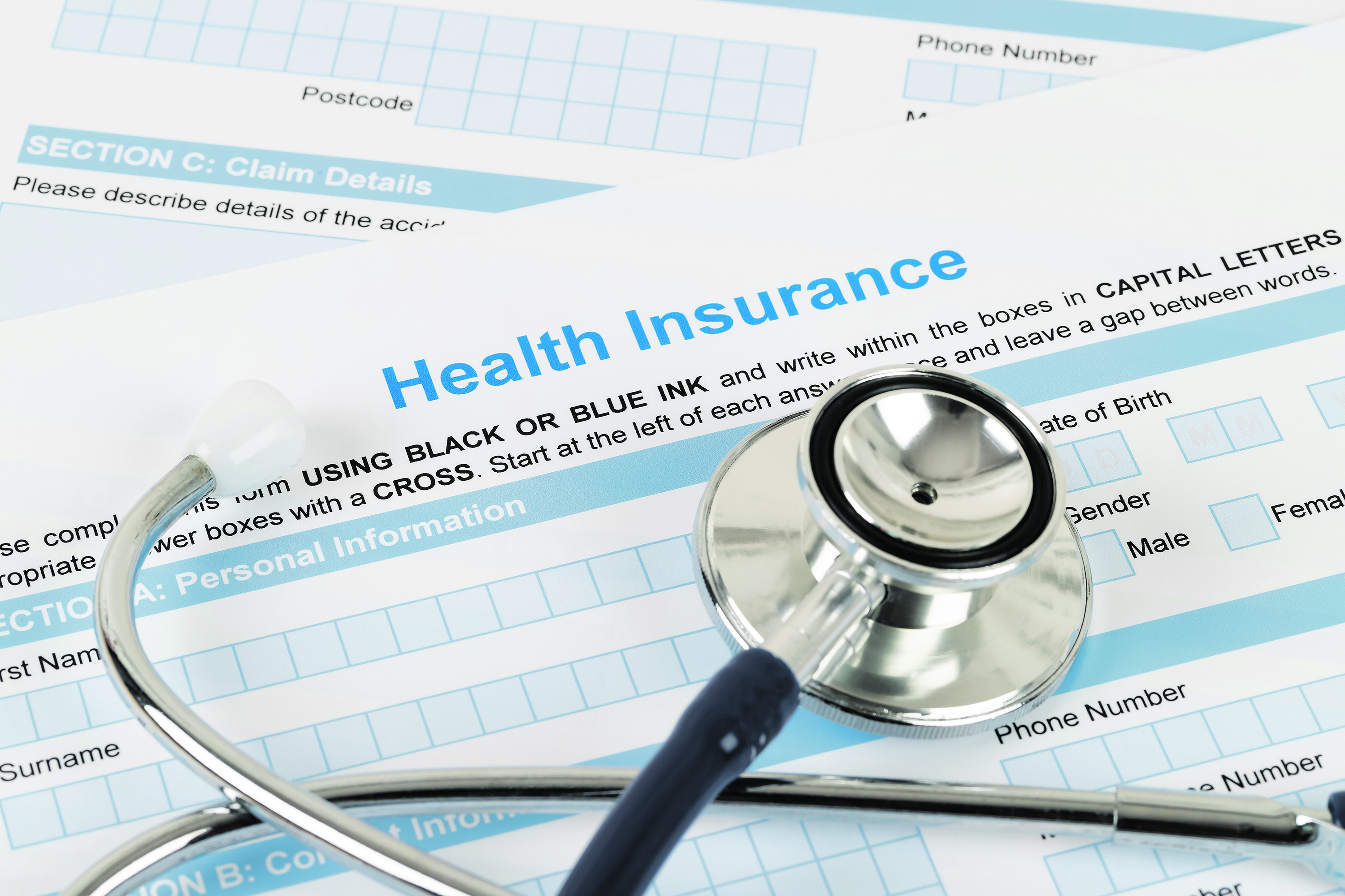 Health insurance application form with stethoscope and calculator
