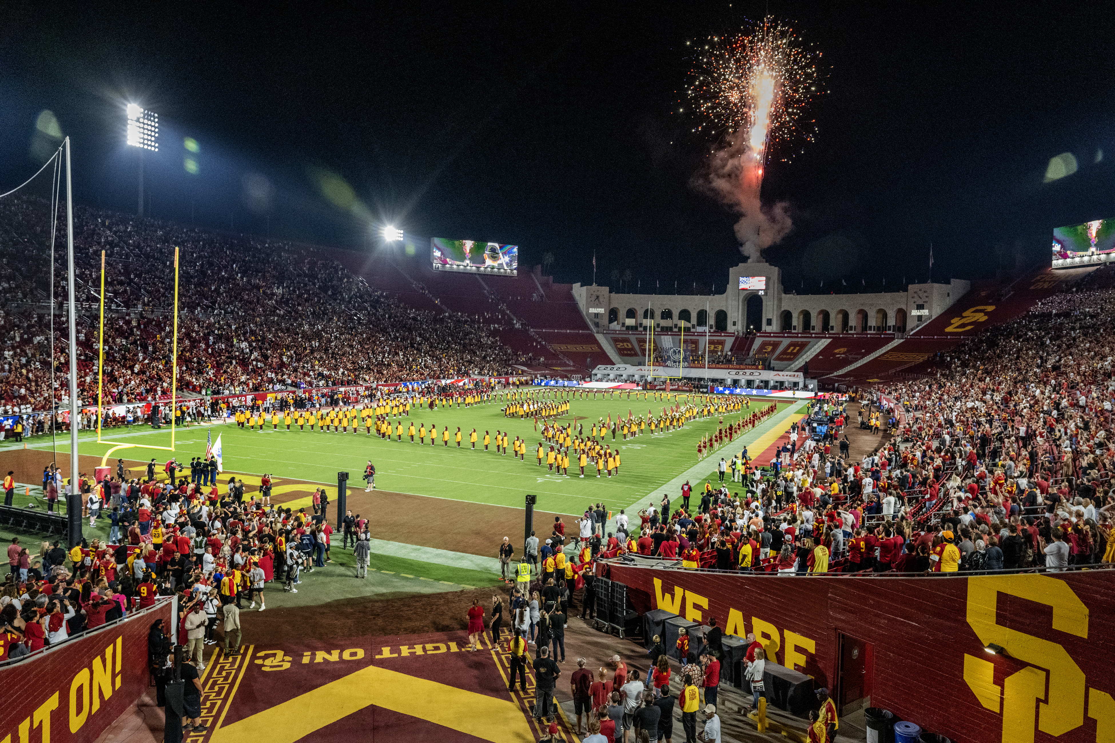 Fireworks flare into the night sky as the Trojan marching band plays the National Anthem at the LA Memorial Coliseum 