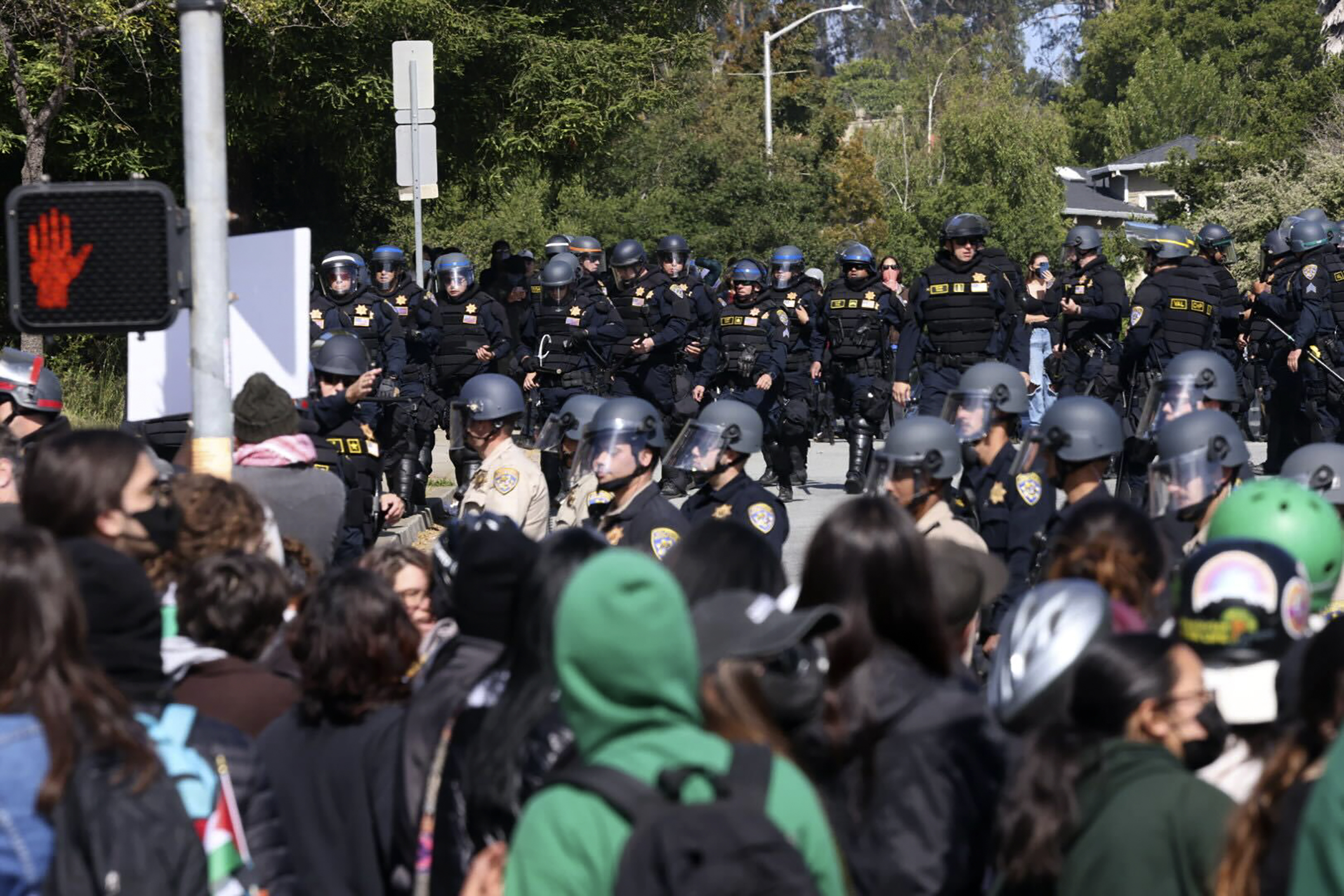 Police in riot gear stand off against pro-Palestinian demonstrators at the University of Santa Cruz on Friday, May, 31, 2024, in Santa Cruz, Calif. Police surrounded protesters to remove the encampment and barricades where pro-Palestinian demonstrations have blocked the main entrance to the campus this week. Many people were arrested, the university said. (Kevin Painchaud/Lookout Santa Cruz via AP)