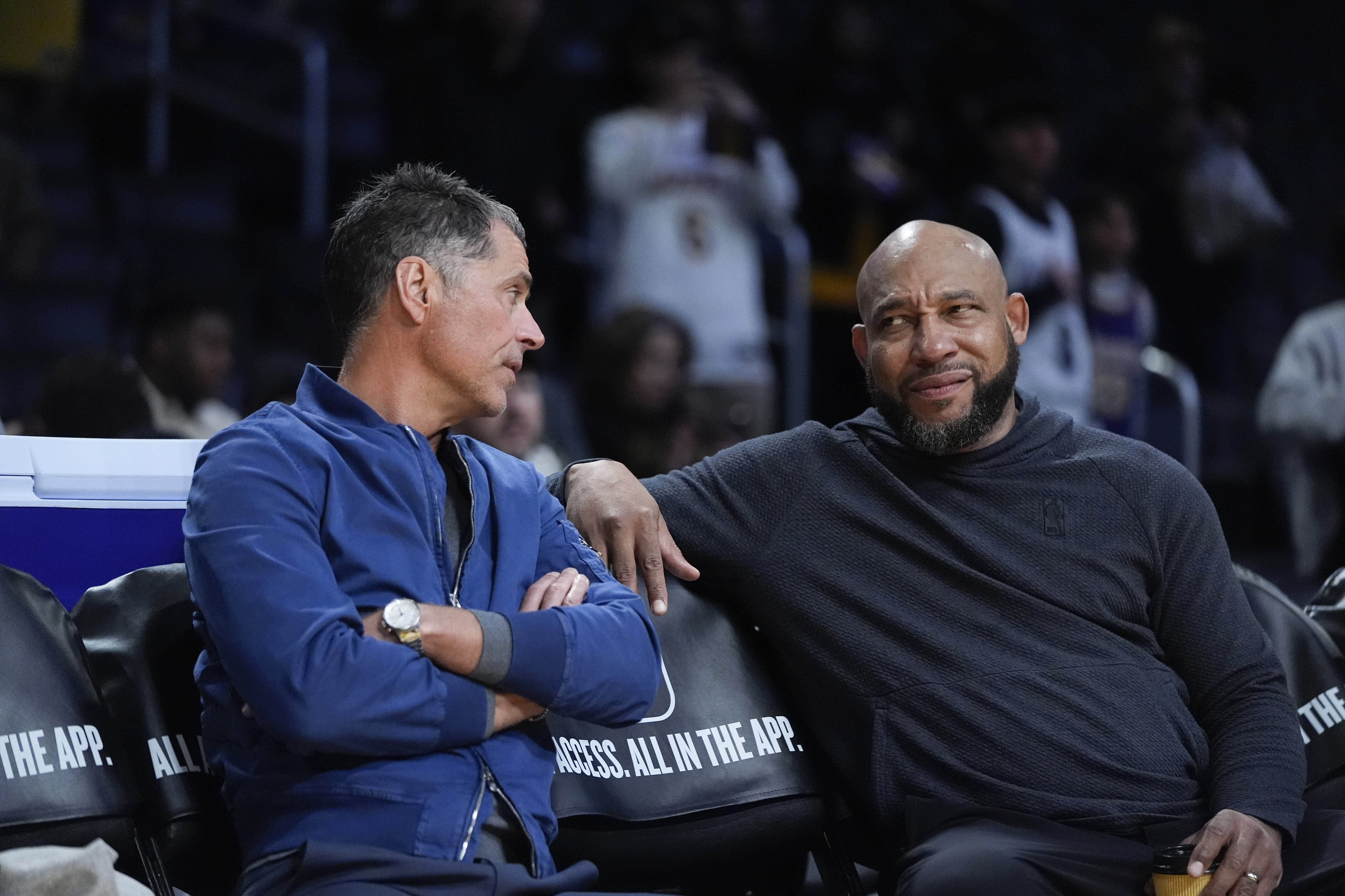 Lakers general manager Rob Pelinka, left, talks with coach Darvin Ham before a game in March.