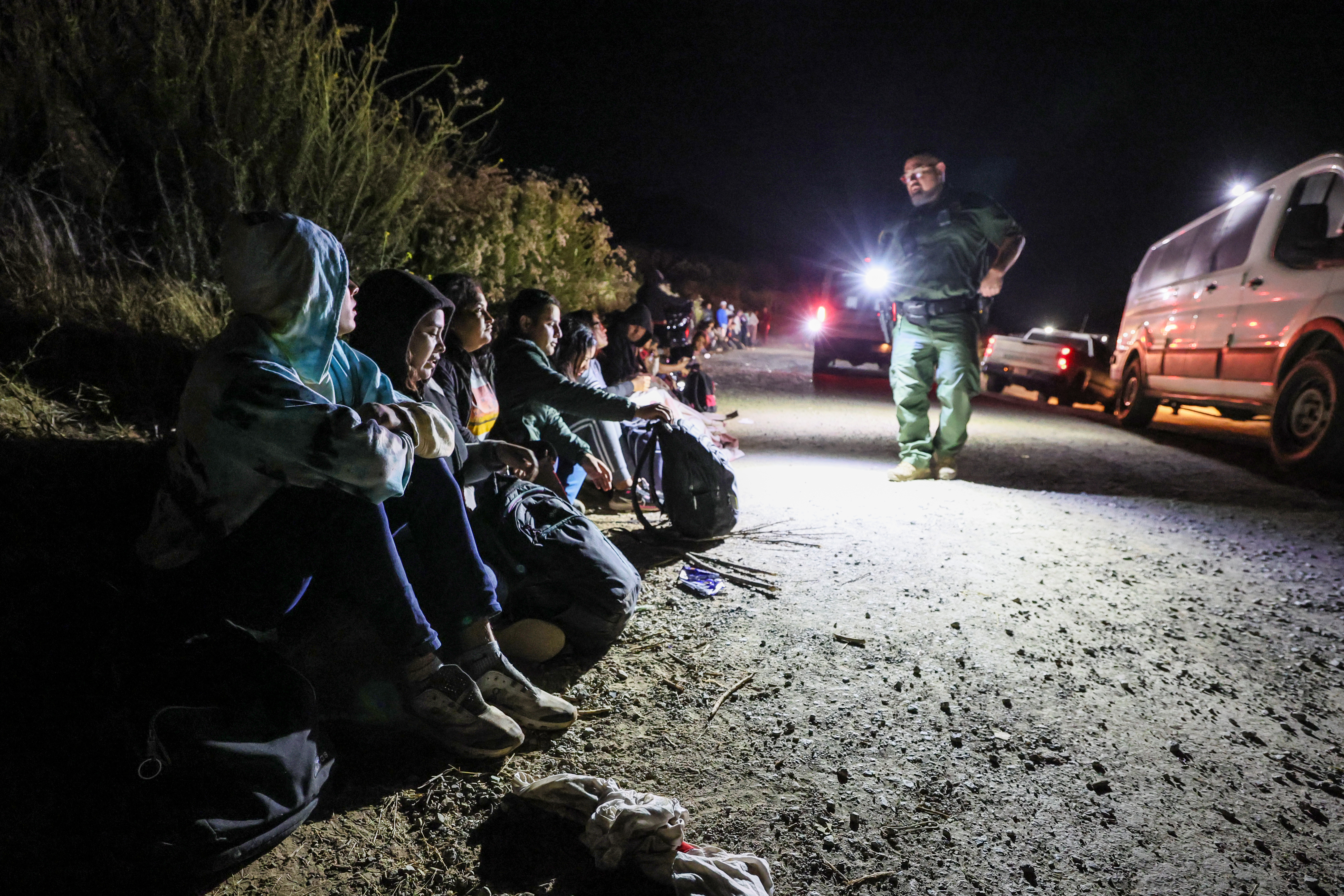 Barrett Junction, CA, Tuesday, June 4, 2024 - Asylum seekers wait to board border patrol vehicles near Campo Rd. after hiking 9 plus hours from the US/Mexco border over Mt. Cuchoma. (Robert Gauthier/Los Angeles Times)