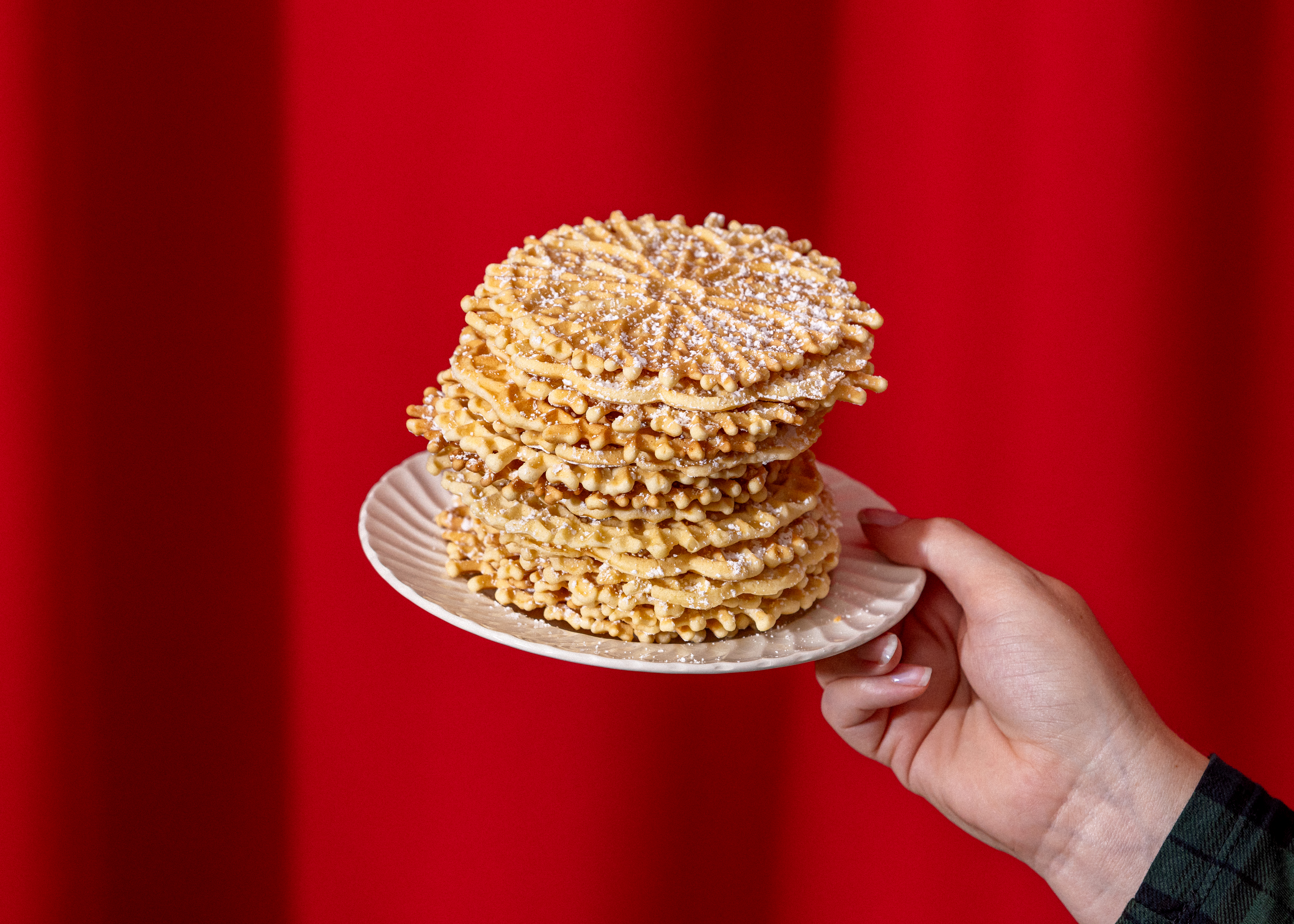 LOS ANGELES, CA - NOVEMBER 14, 2023: A stack of thin and crispy Italian pizzelle cookies from Lupe Del Rivo, a member of the Garibaldina Society, photographed on Tuesday, Nov. 14, 2023, at the Garibaldina Society in Los Angeles, CA. (Silvia Razgova / For The Times)