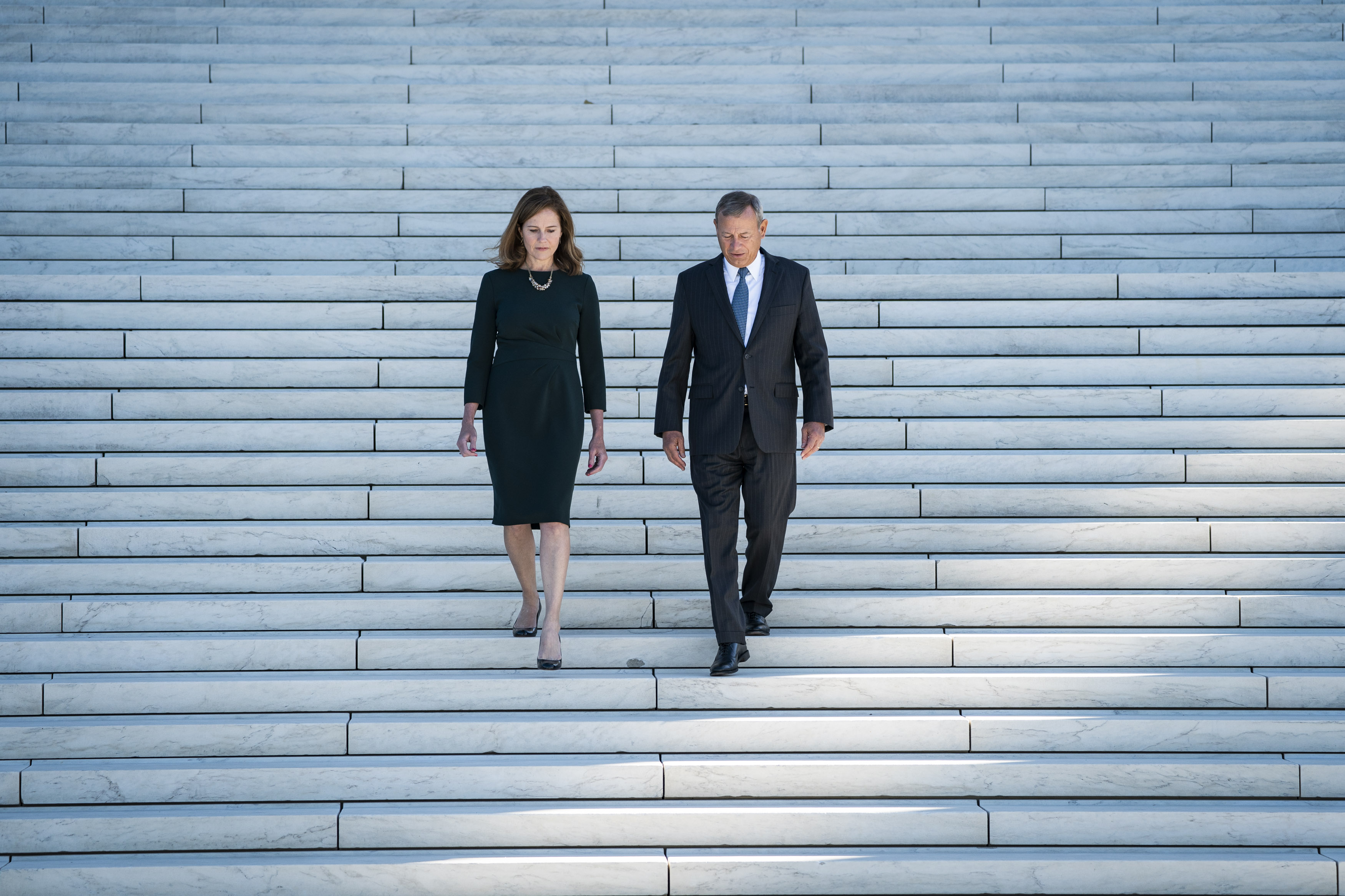 WASHINGTON, DC - OCTOBER 1: Associate Justice Amy Coney Barrett is escorted out after an investiture ceremony by Chief Justice of the United States John Roberts at the Supreme Court on Friday, Oct. 01, 2021 in Washington, DC. (Photo by Jabin Botsford/The Washington Post via Getty Images)