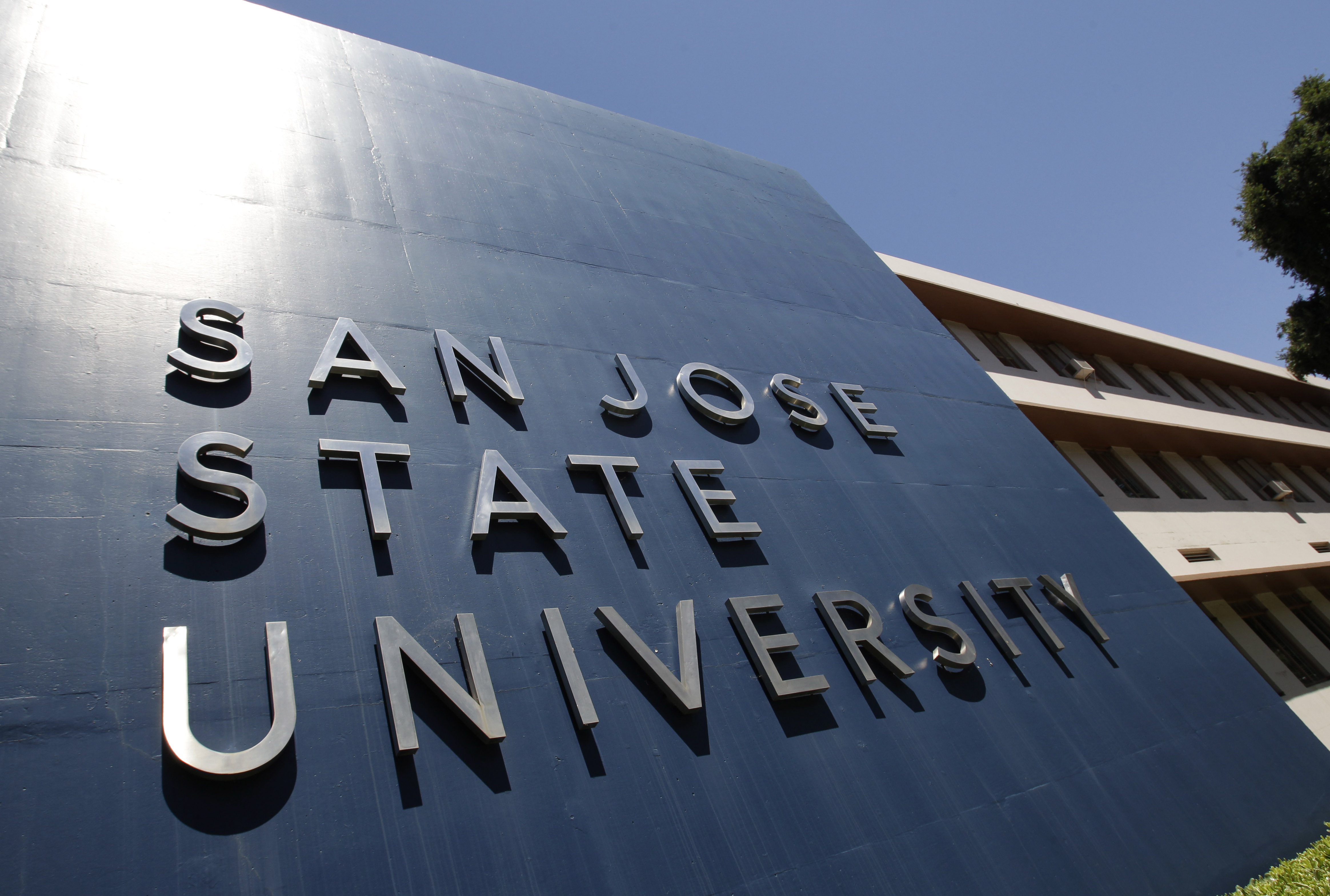 FILE - This June 30, 2011, file photo, shows an exterior view of San Jose State University in San Jose, Calif. The president of San Jose State University resigned Thursday, Oct. 7, 2021, after the university agreed last month to pay $1.6 million to 13 female student-athletes whose complaints about being sexually assaulted by an athletic trainer were mishandled. (AP Photo/Paul Sakuma, File)