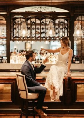 Wedding couple celebrate at the lobby bar.