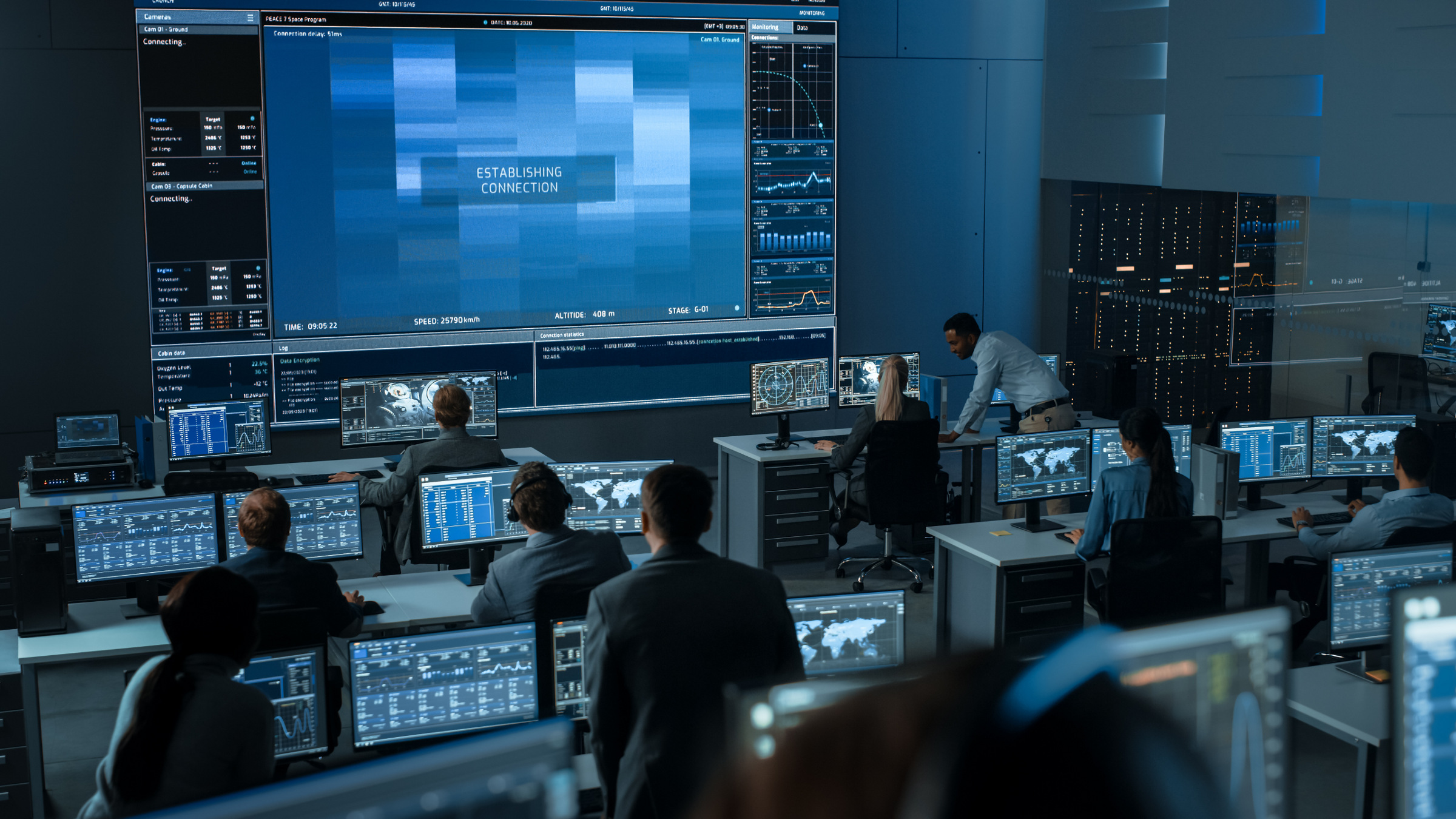 workers at computers in mission control setting