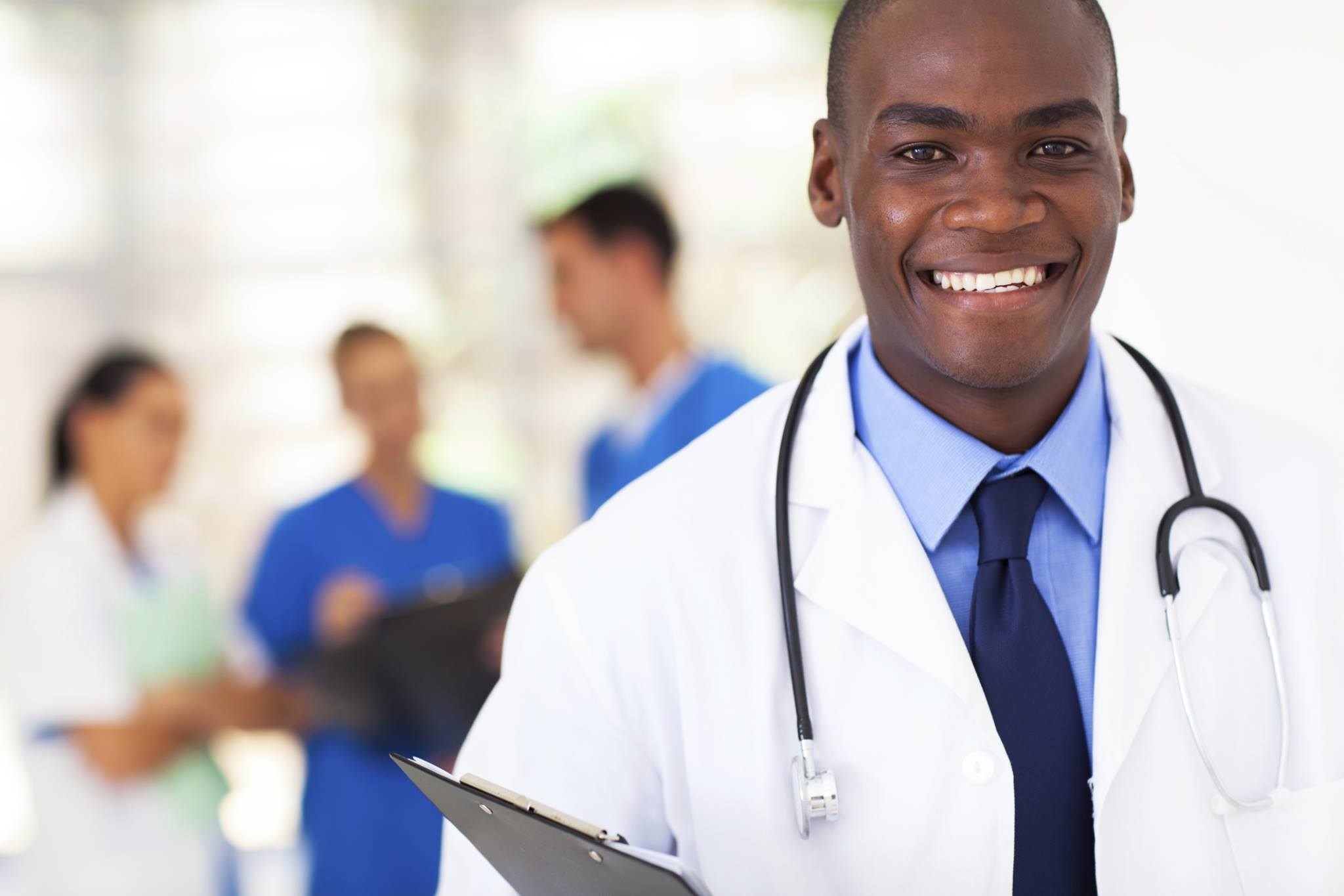 black male doctor smiling at the camera