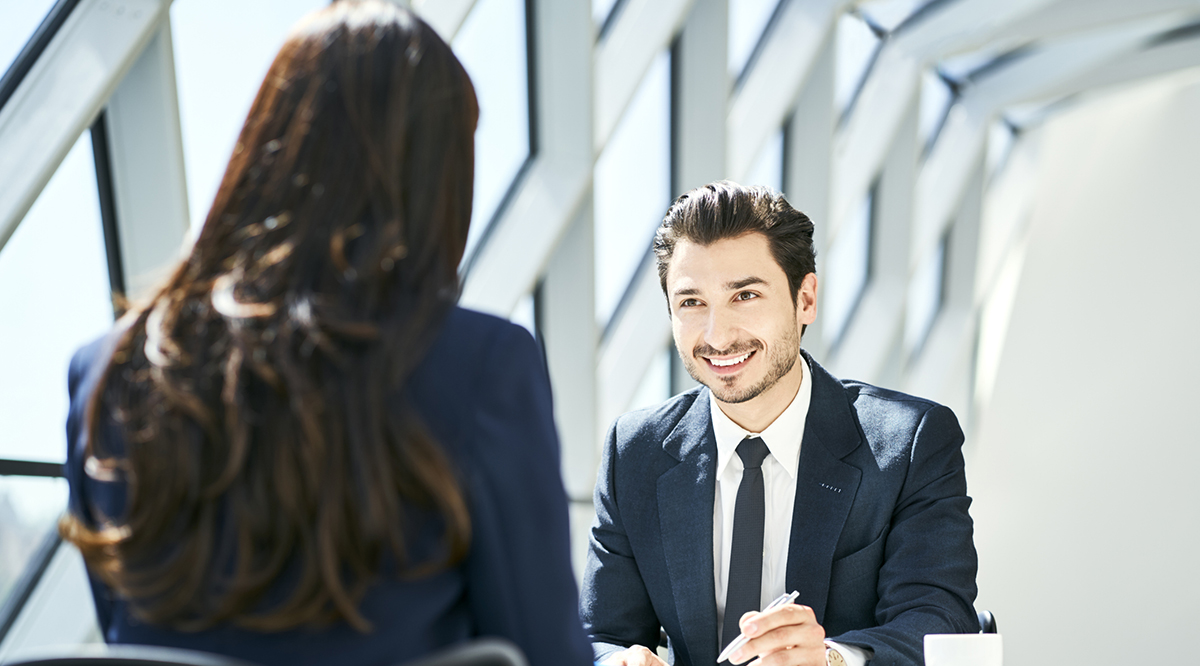 student in suit smiling at interviewer