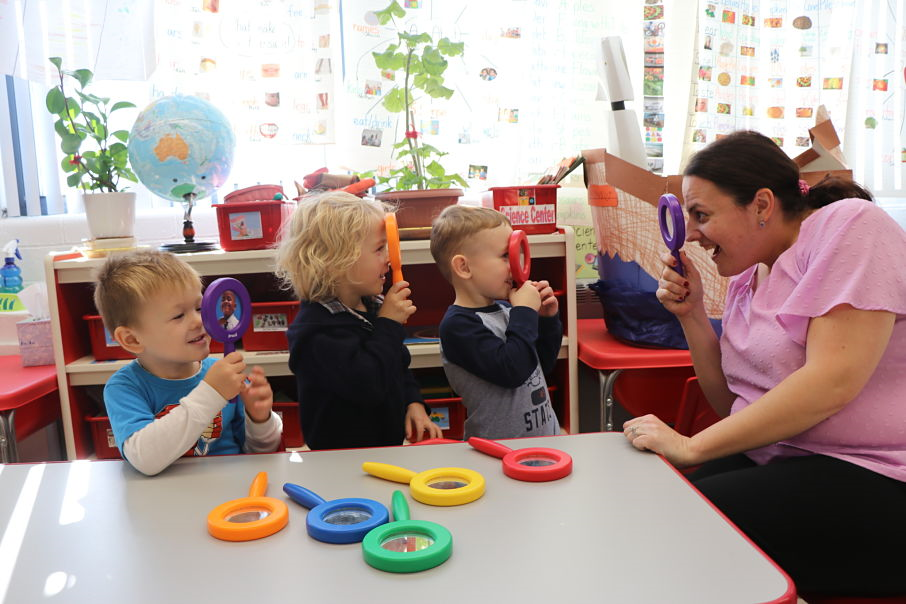 Young children using magnifying glasses