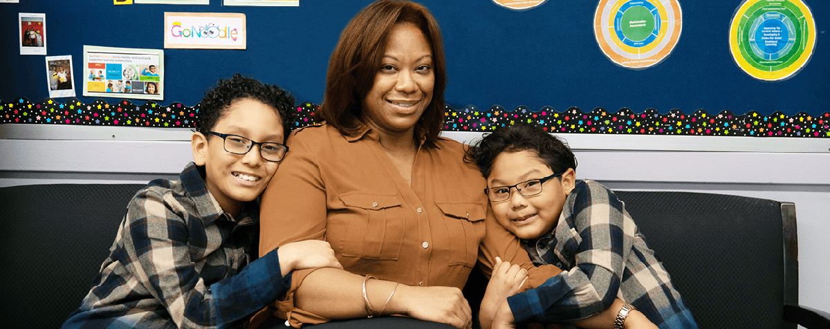 A mother and two students visit their local Family Welcome Center