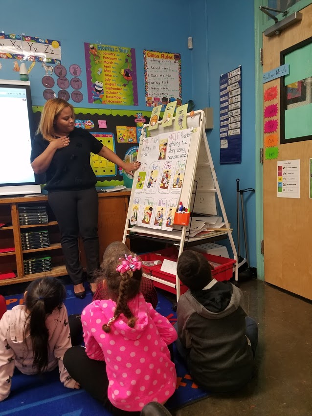 teacher explaining sequence words to young students