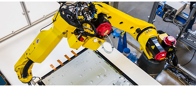 Industrial robot arm performing precision work on an assembly line.