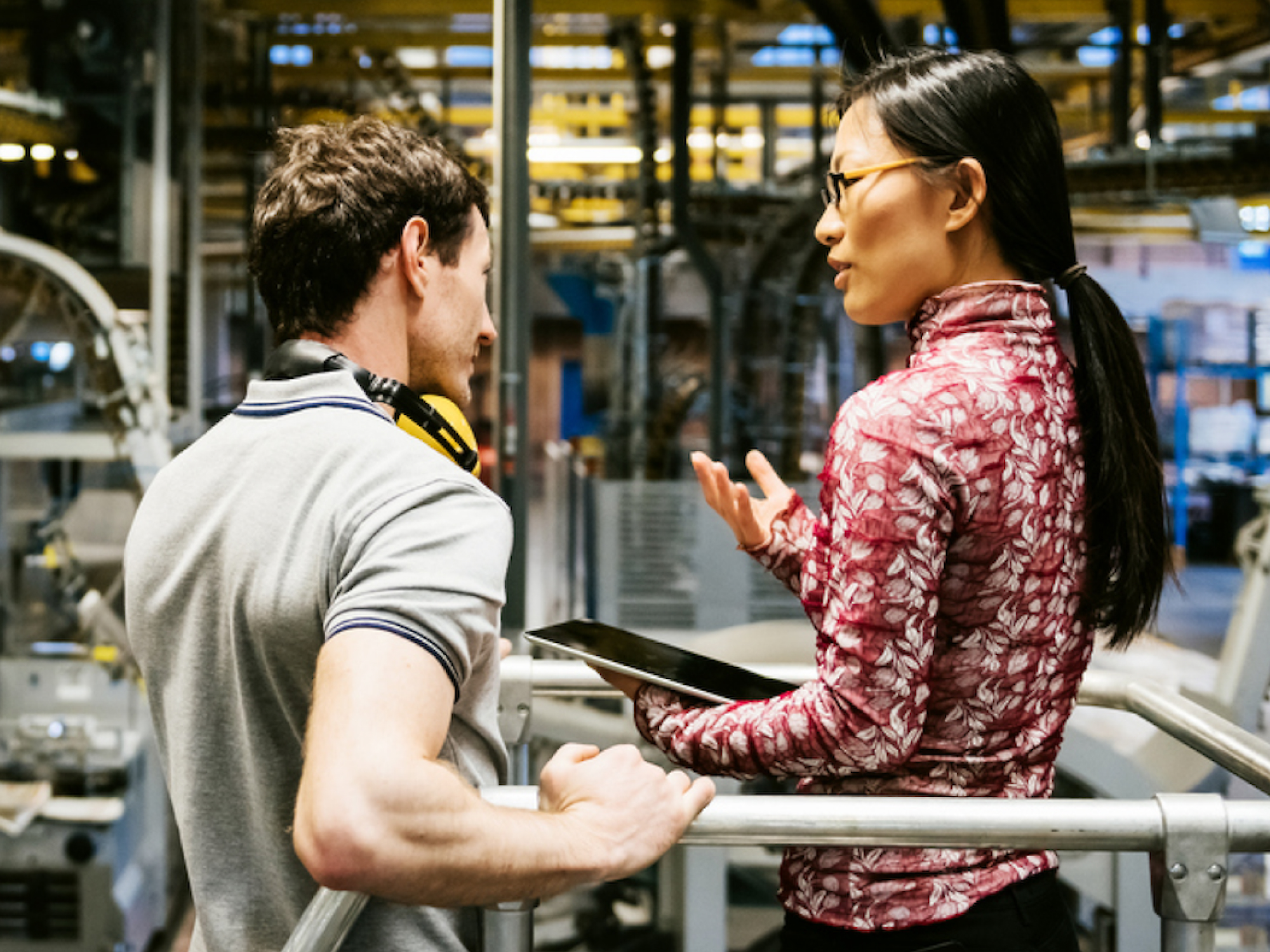 A man and a woman working on a factory floor