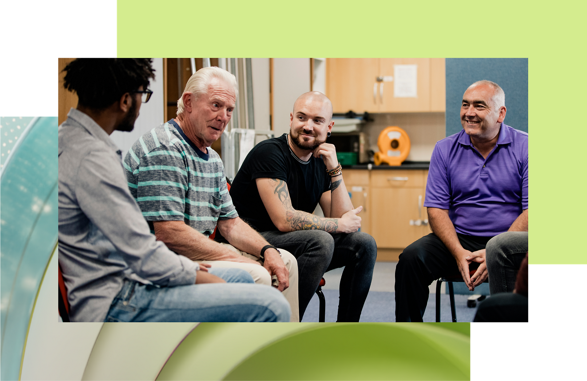 Four men engaged in a discussion while sitting in a room with colorful decor.