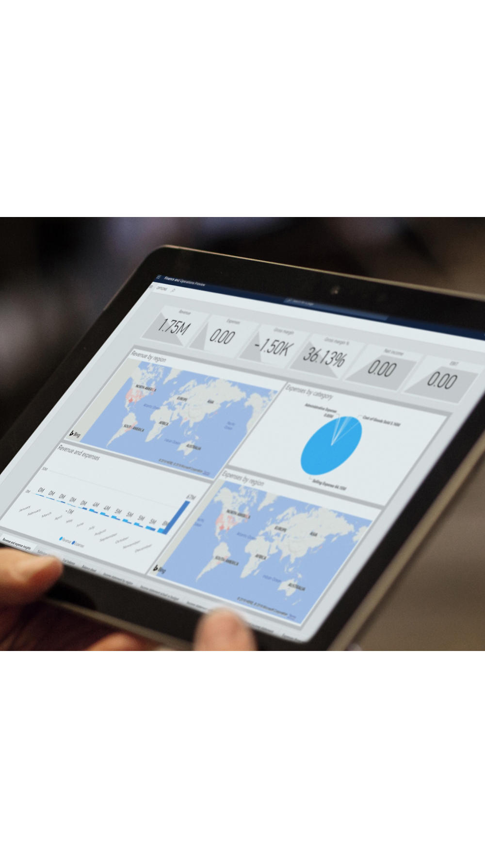 A person holding a tablet displaying analytics charts, including maps and graphs, reflecting global data metrics.