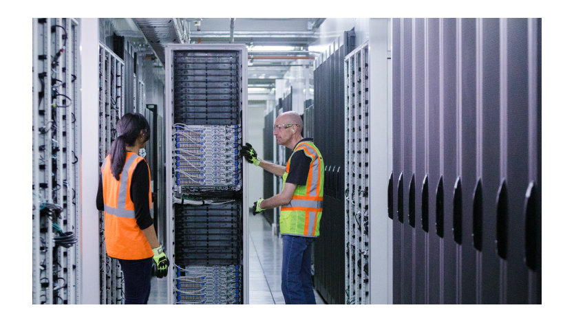 Datacenter Service Technicians in server aisle.