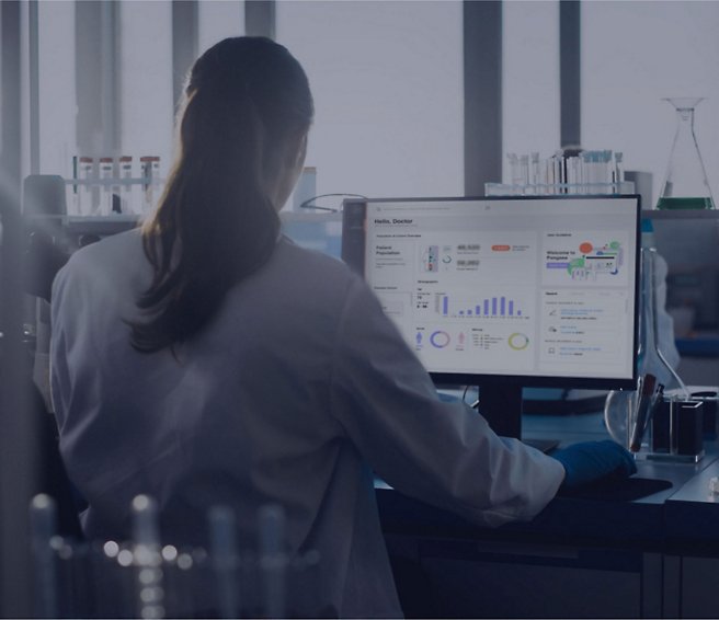 A person in a lab coat working on a computer