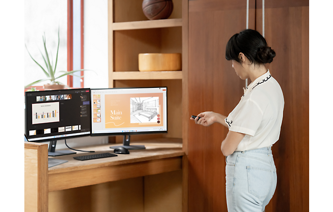 A girl standing in front of a computer