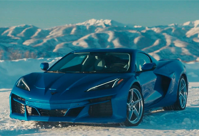 The 2020 chevrolet corvette stingray is driving through the snow.