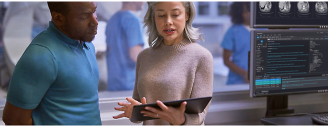 Two people looking at a tablet screen