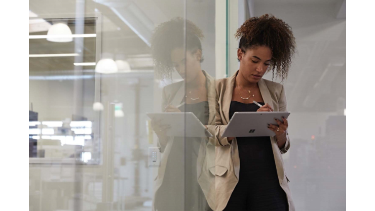 A woman writes with Surface Pen on a Surface tablet