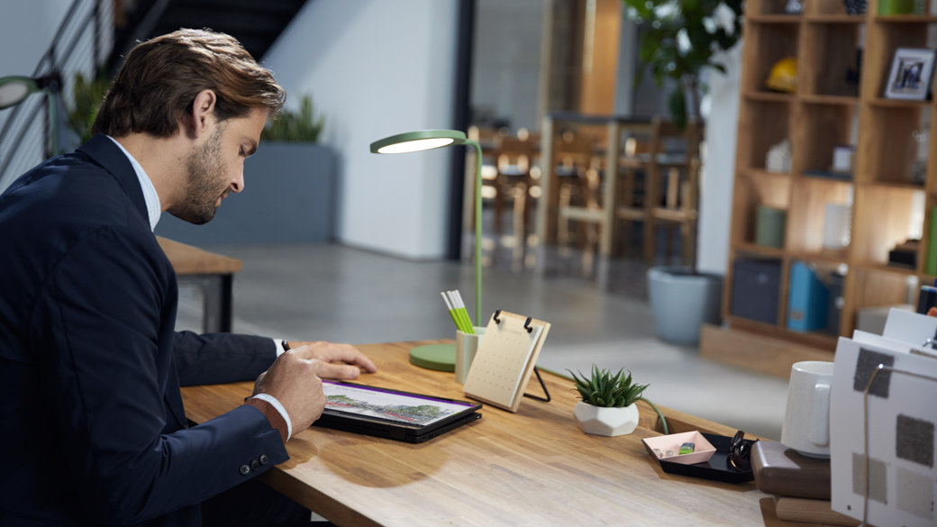 Man sitting at a desk working on his computer