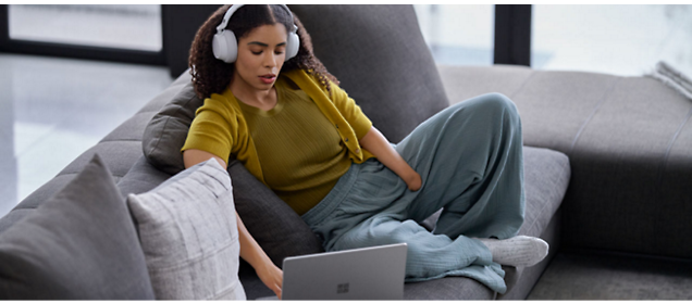 A girl wearing headphone and working on laptop.