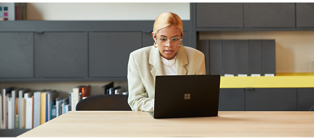 A person sitting at a desk using a computer