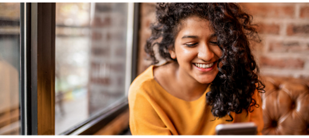 A girl smiling with curly hair