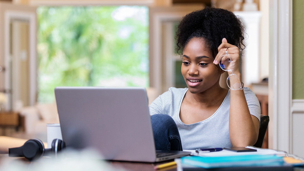 Photo credit: iStock/SDI Productions/Getty Images. Female college student uses laptop to study at home