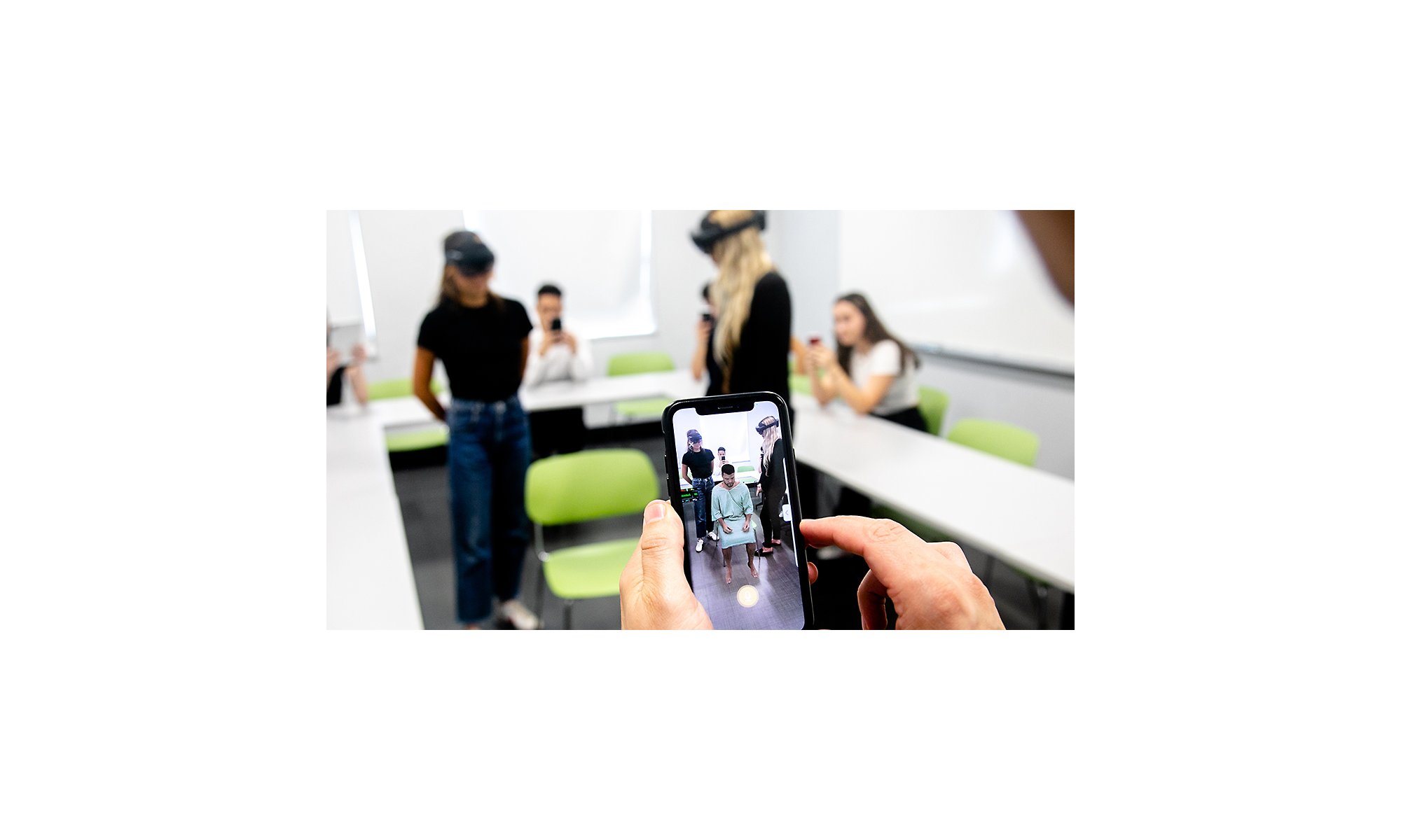 Medical students using HoloLens 2 to view a patient.