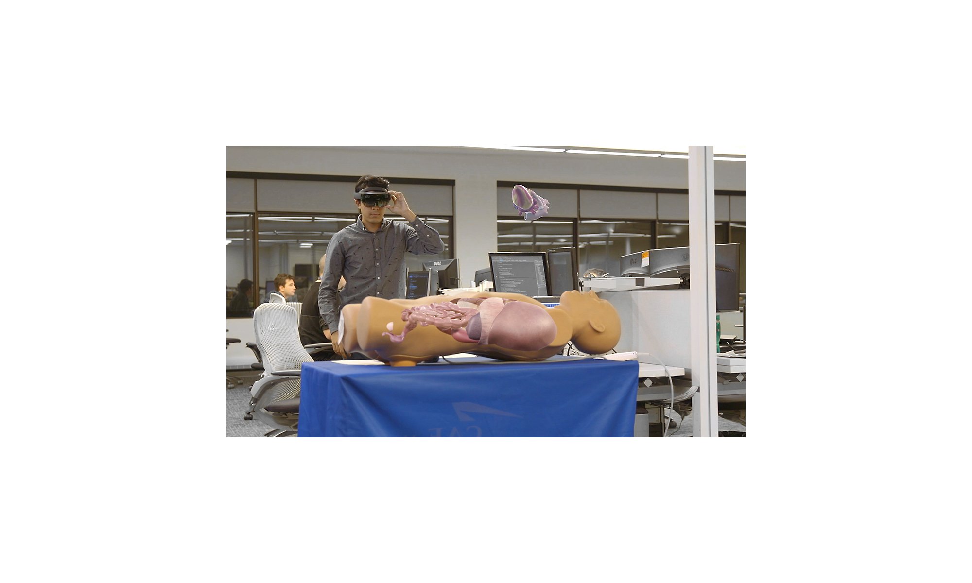 A person using a HoloLens 2 device to view an anatomical display.