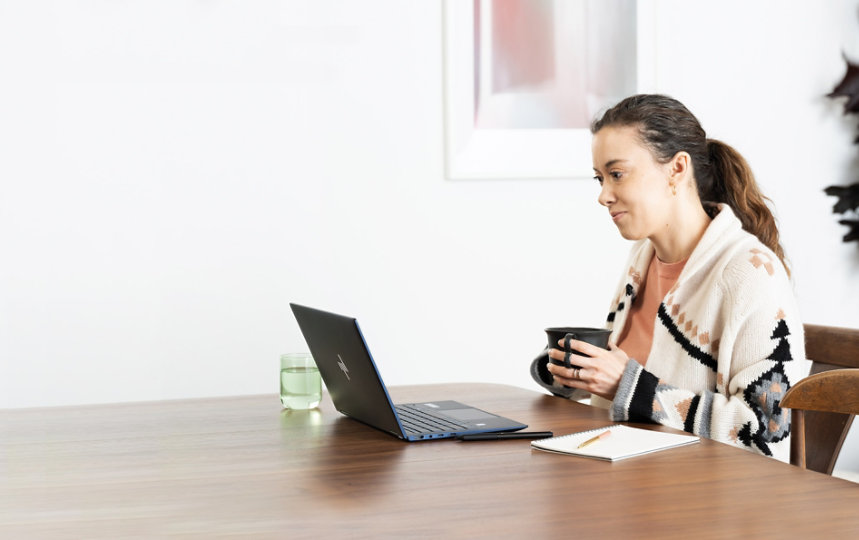 A woman working on her laptop at home. 