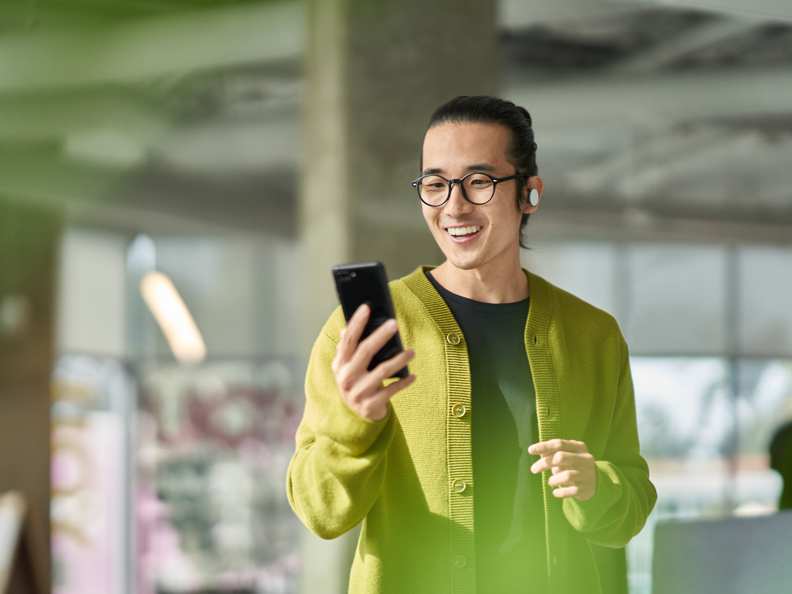 A person smiling while looking at a phone