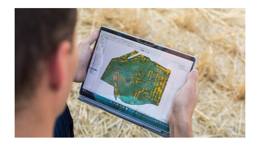 A man peers at a map on his tablet.