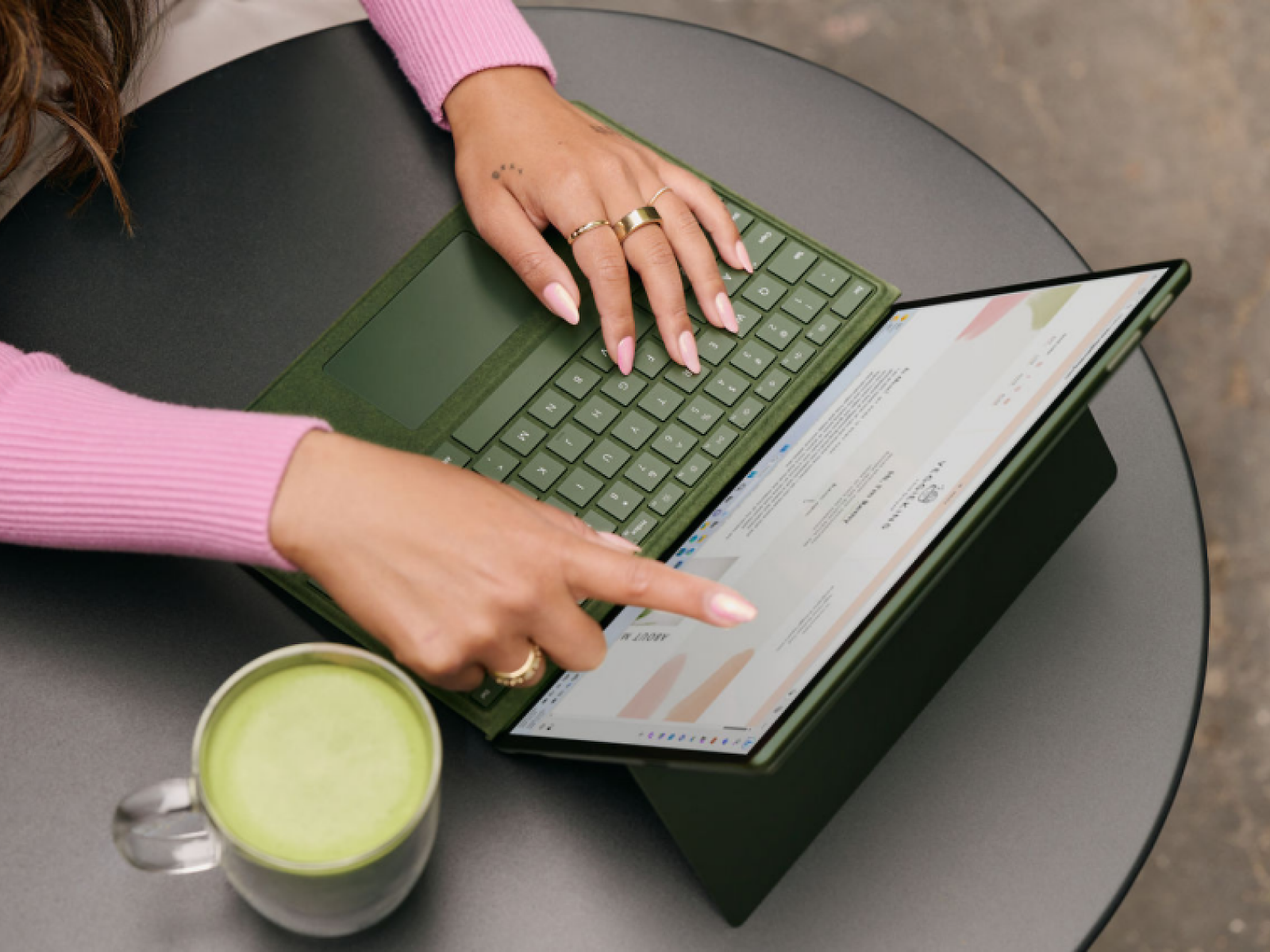 A person's hands working on a computer