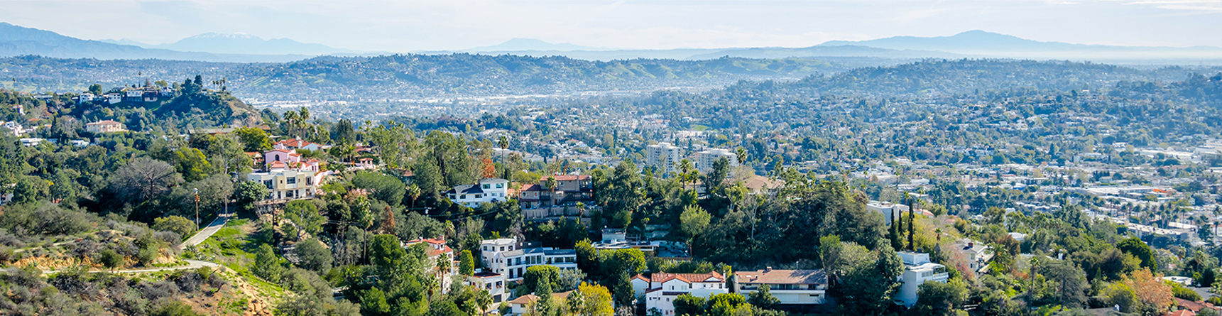 Aerial view overlooking hills and luxury, Spanish-styled homes