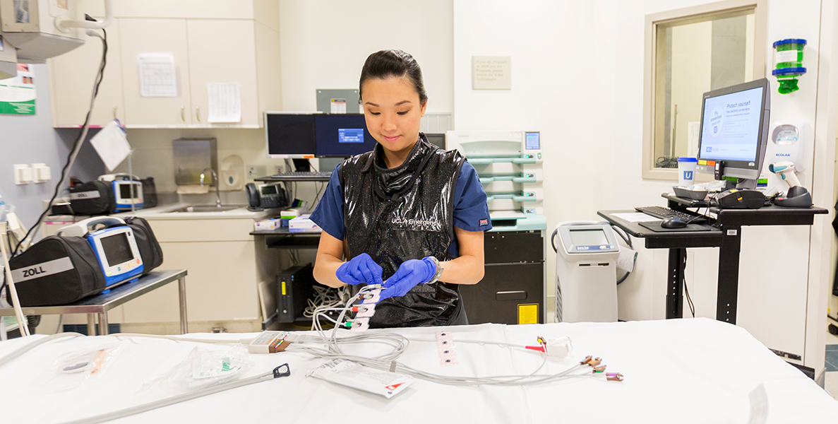 Female nurse preparing equipment within advanced emergency room setting