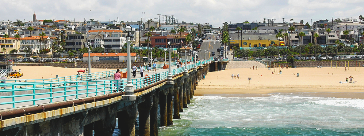  Looking down long pier toward the beach and neighboring beachside town